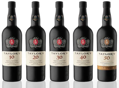 Five bottles of Taylor's Port Wine varieties including 10, 20, 30, and Gold labels with ornate crests